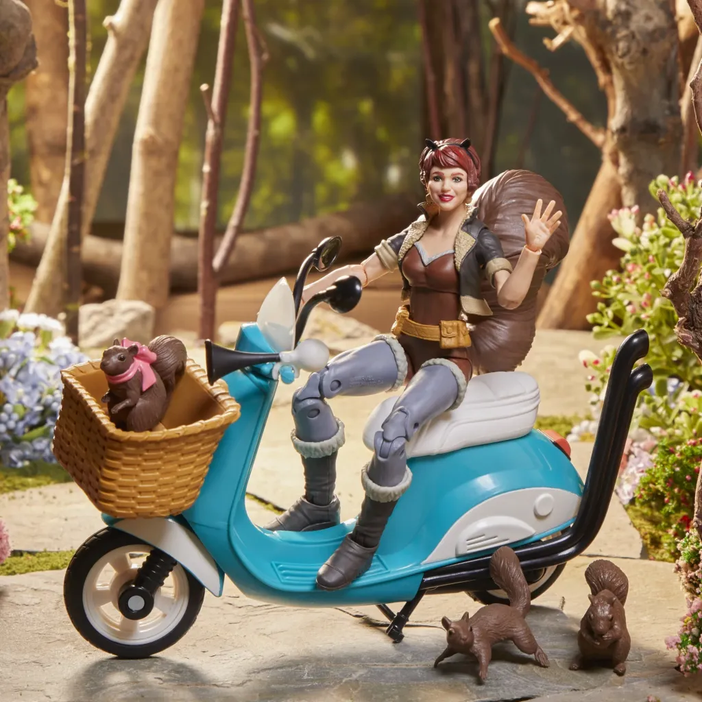 Marvel Legends Unbeatable Squirrel Girl 6-Inch Action Figure, featuring detailed sculpting of Squirrel Girl's signature outfit, bushy tail, and vibrant accessories including her pet squirrels Tippy-Toe and Monkey Joe, and a blue-and-white moped with turning wheels.